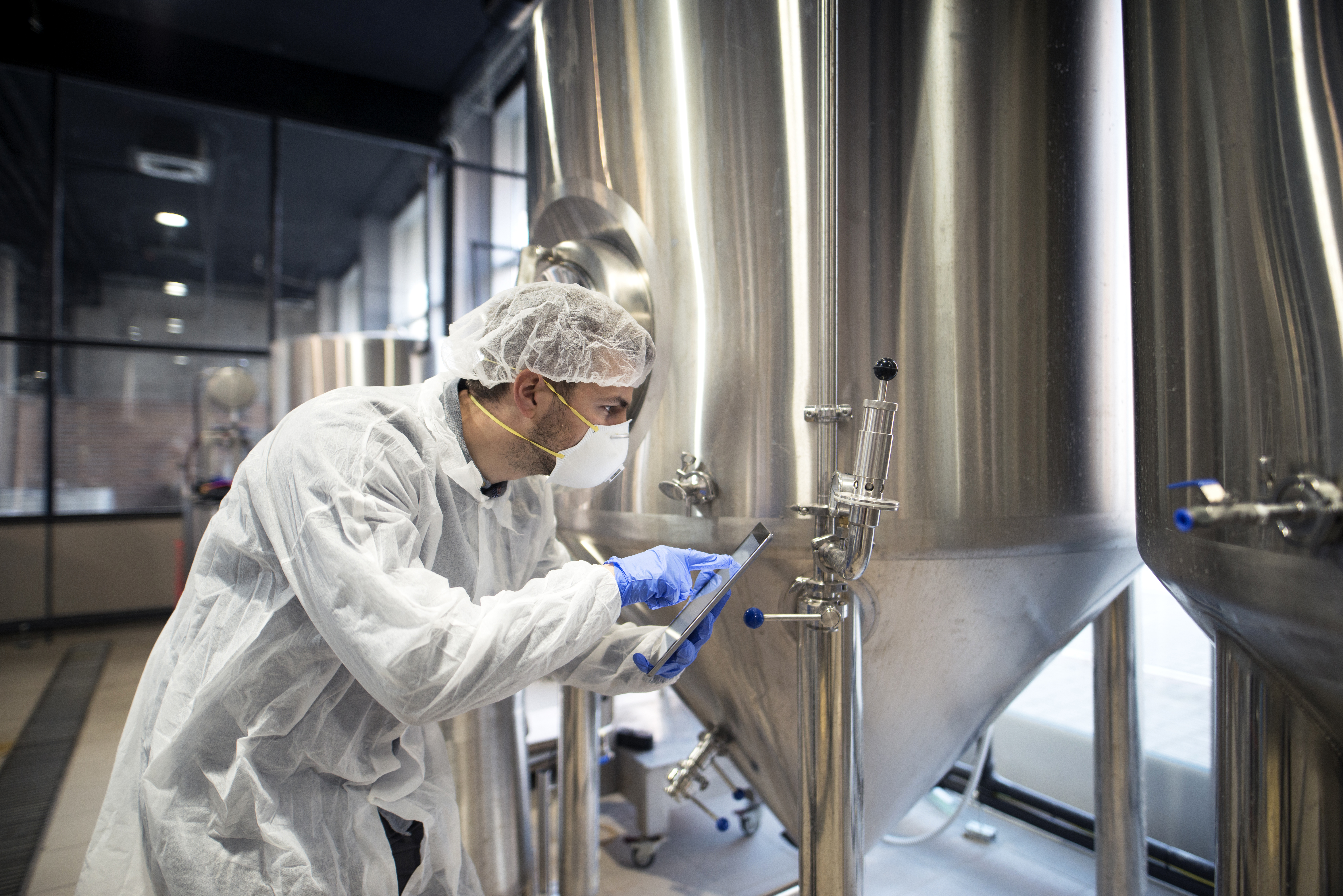 Professional technologist checking production in factory.